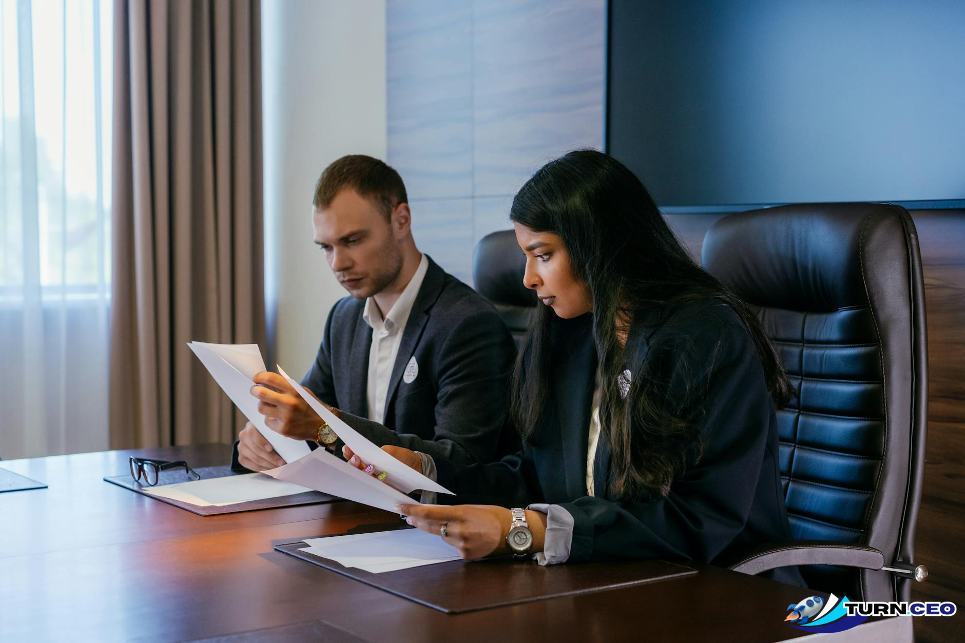 business professionals reviewing compliance documents at a conference table
