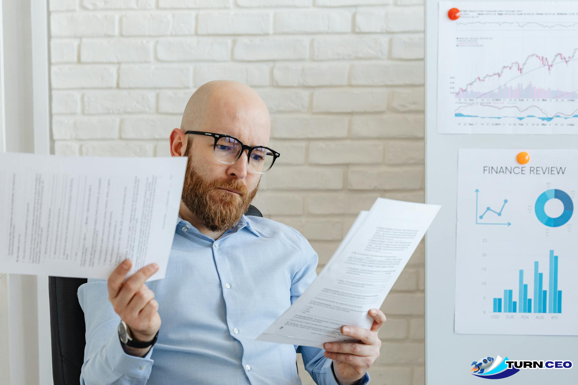 Business owner reviewing cash flow charts and financial documents at desk