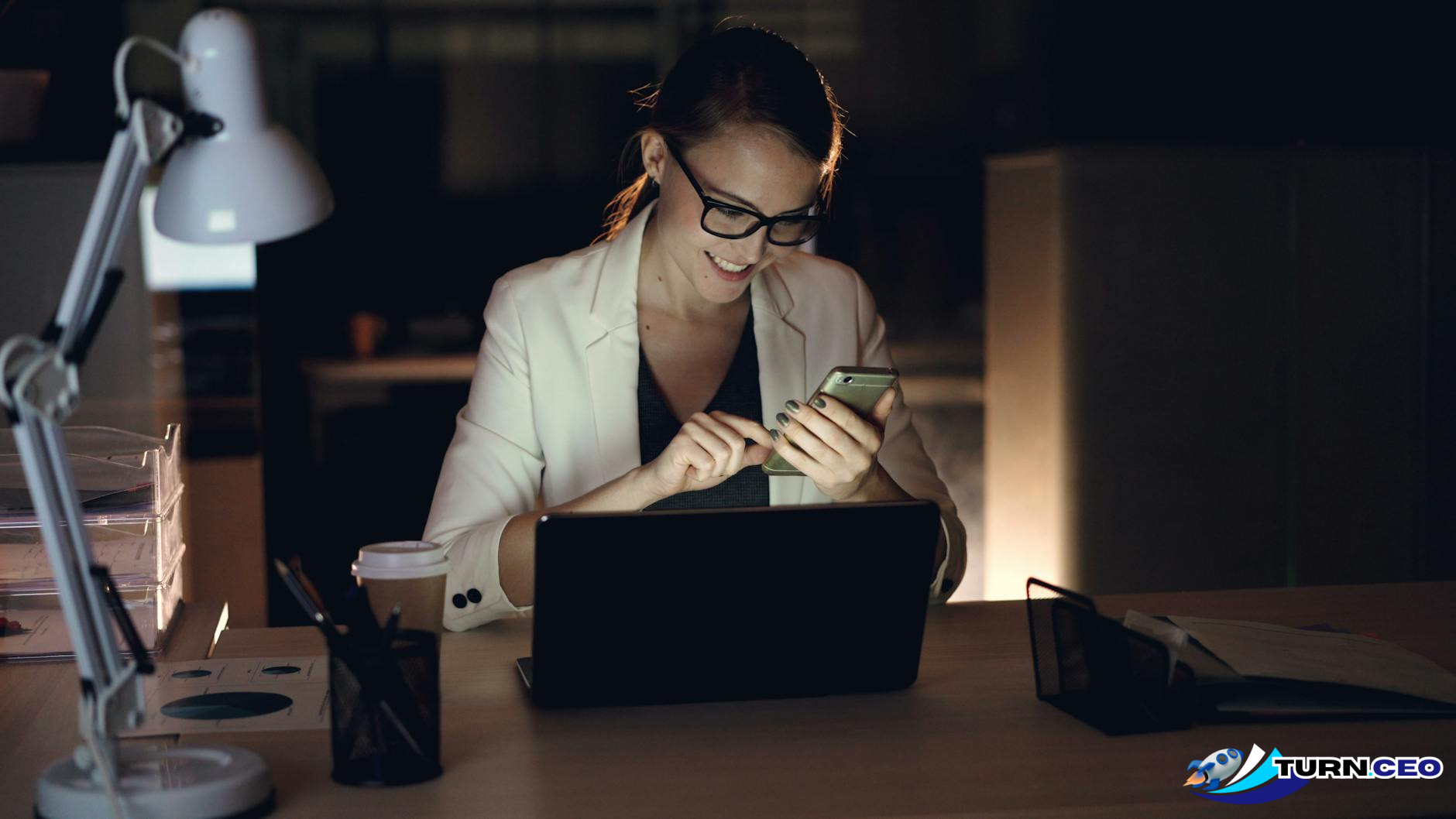 Entrepreneur working late at night with multiple screens showing business planning documents