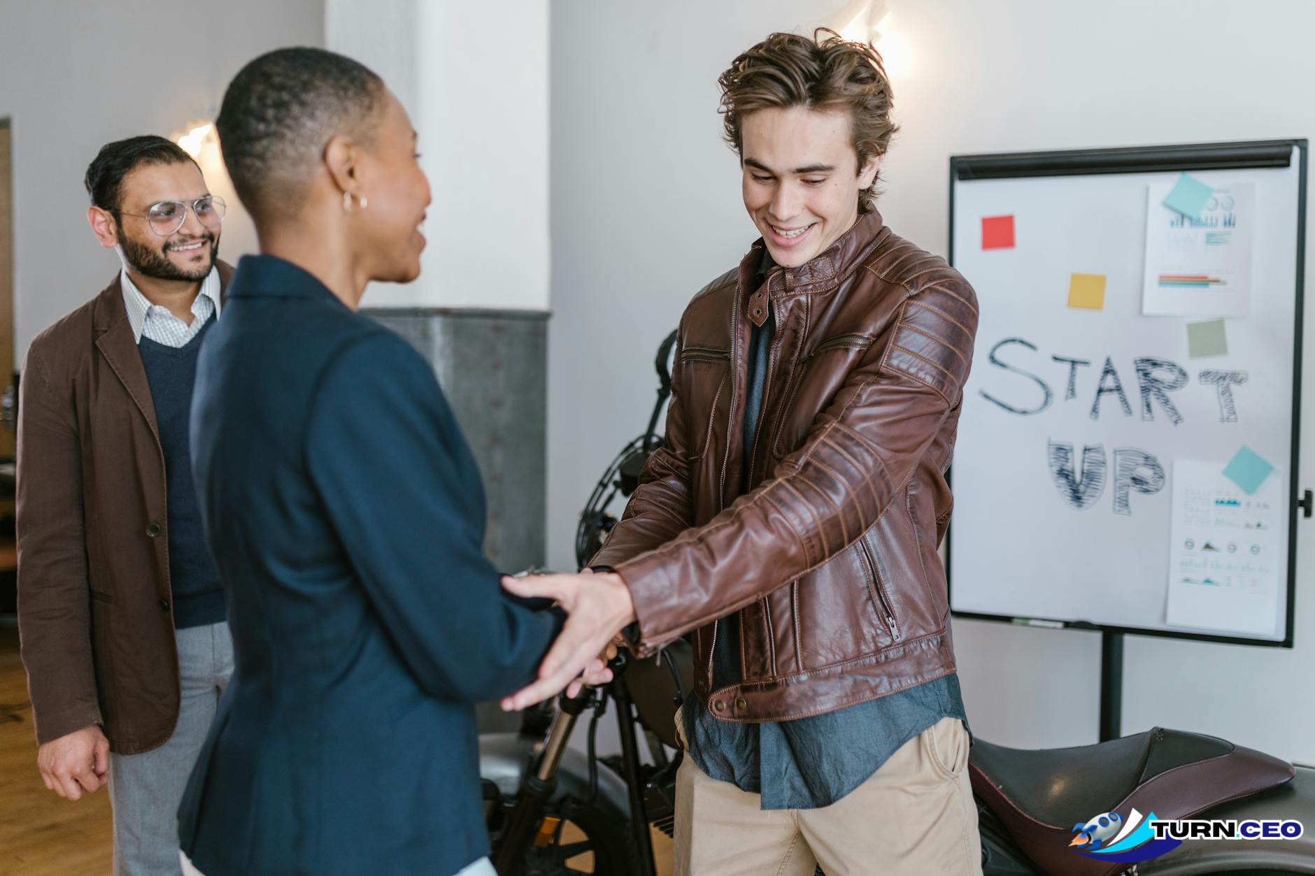 small business owner shaking hands with customer in professional setting