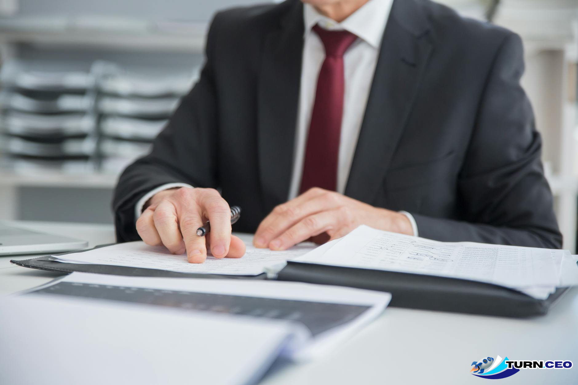 Professional business executive reviewing strategic documents at desk